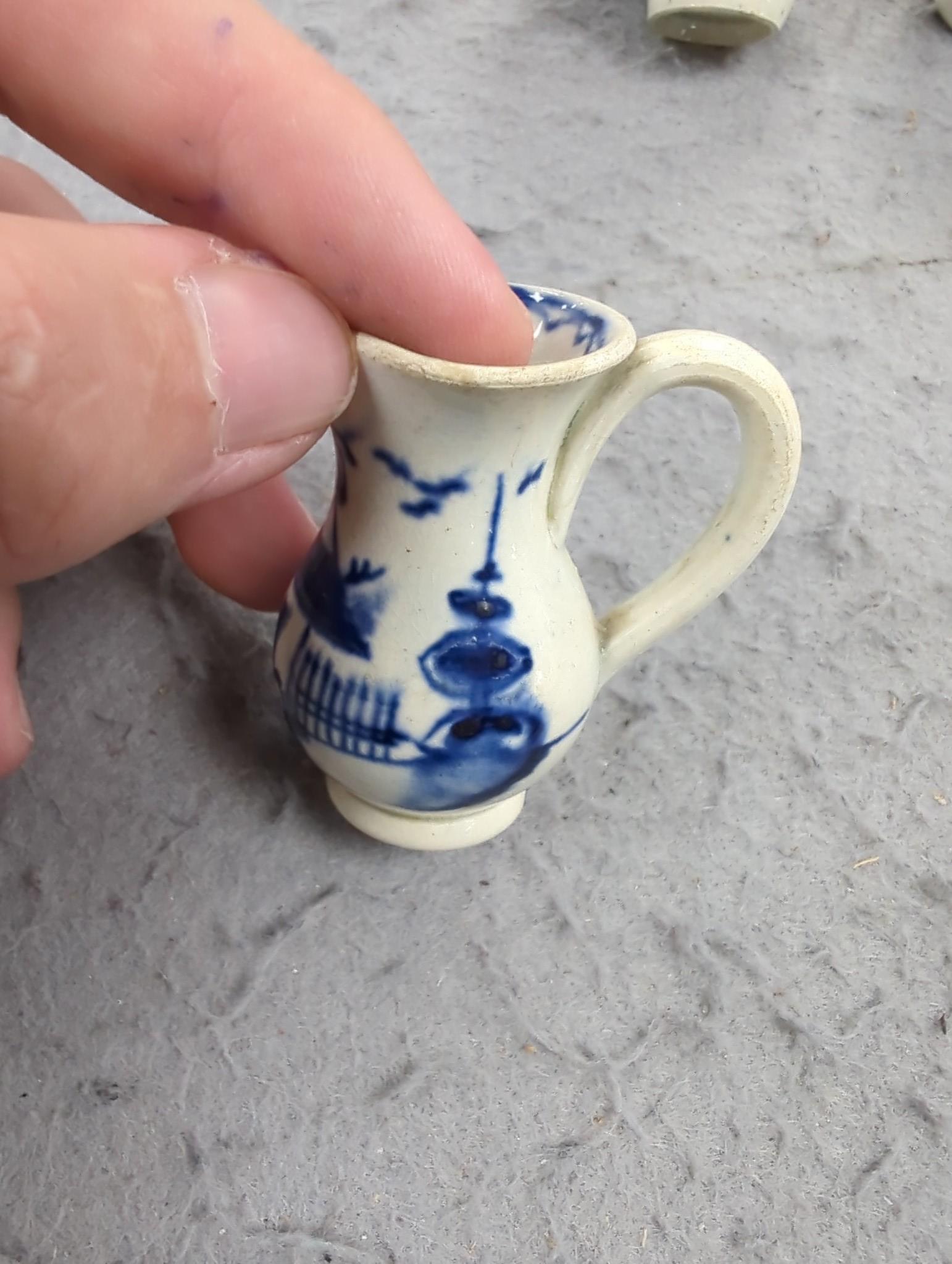 A late 18th century pearlware blue and white miniature jug, 5cm, and tea bowl and an English porcelain miniature mug, late 18th century